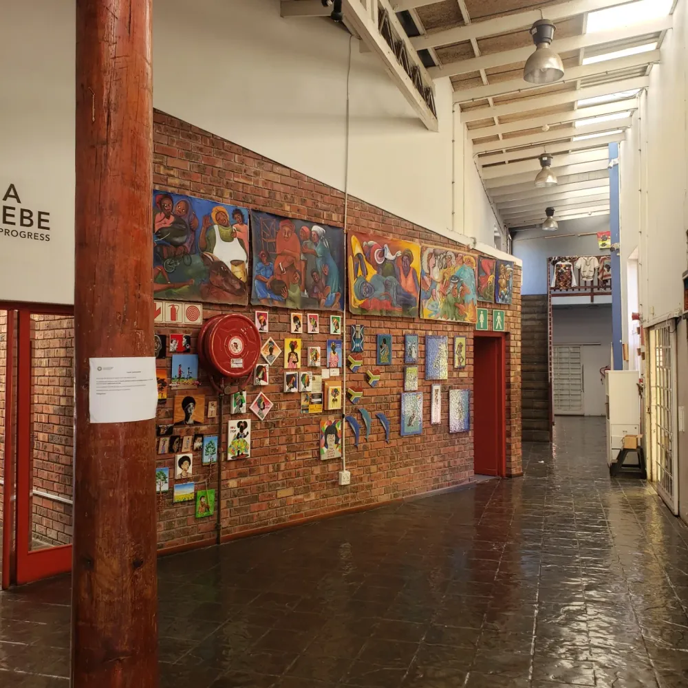 Gallery corridor at Guga S'thebe hung with paintings